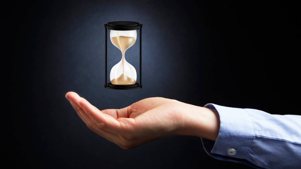 a sand hourglass over a hand to represent the effective timeline of cockroach gel