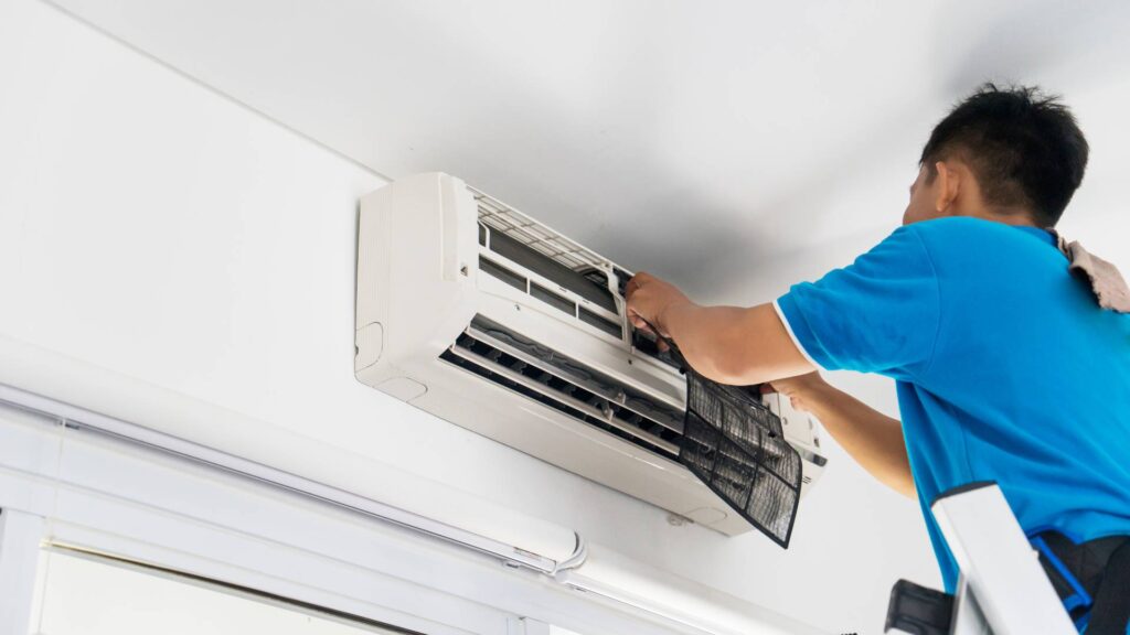 open ac with a guy working on How to Mouse Proof an Air Conditioner