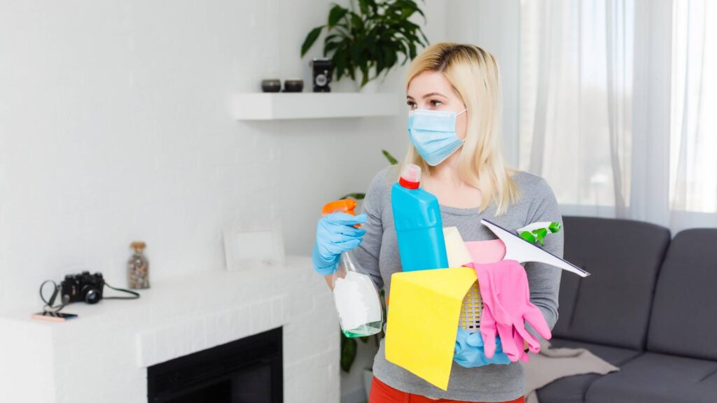 woman with cleaning supply to prepare for a fumigation service on her house and minimize the cost f it.