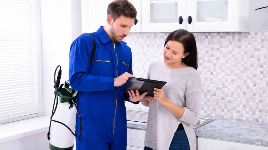 pest control professional giving input to a woman on when to call for help and what is best bug bomb for stink bugs