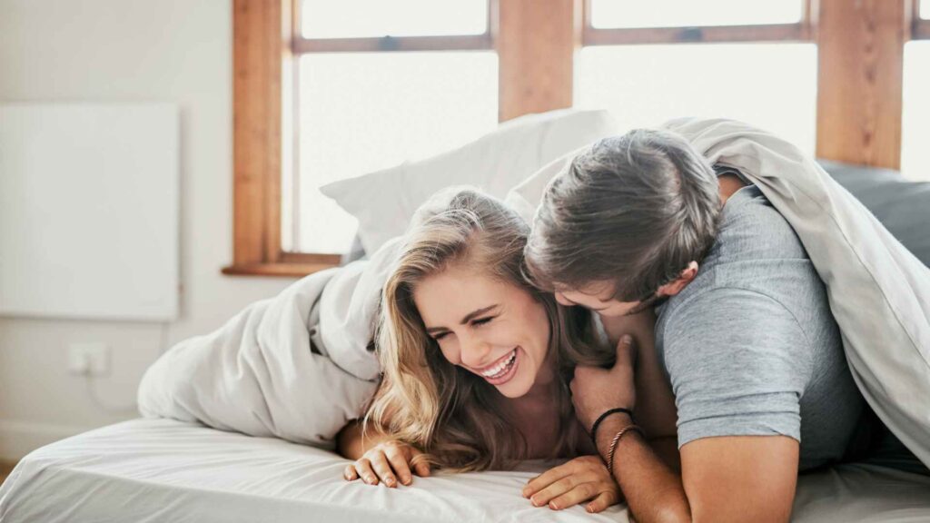 couple on a bed hugging each other because the followed prevention advices for bed bugs in bed