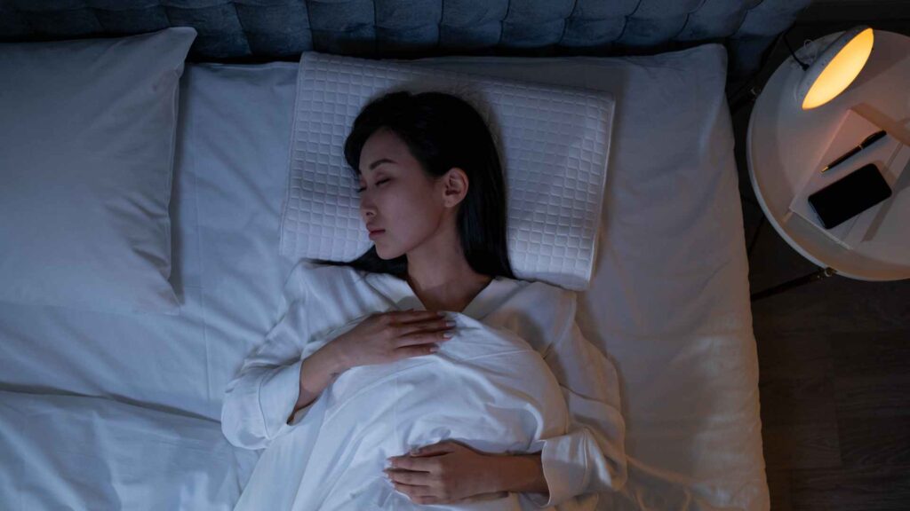 woman peacefully sleeping with an ant free bed