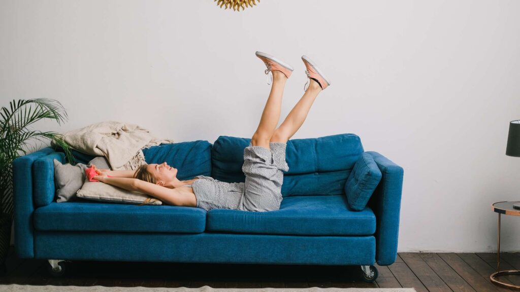 woman jumping on a couch to illustrate what are the signs of mice living in your couch